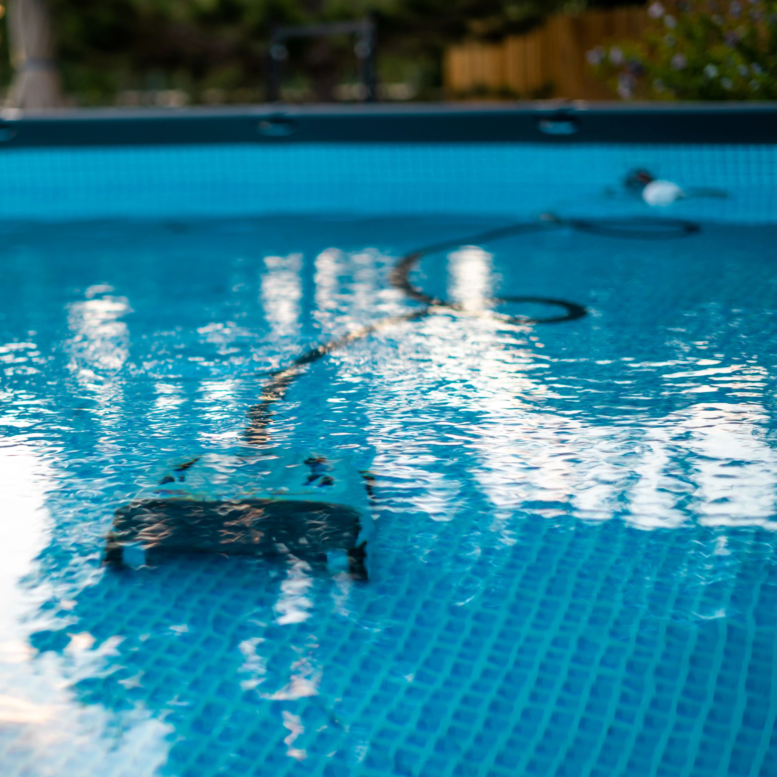 A robotic pool cleaner submerged in a swimming pool.