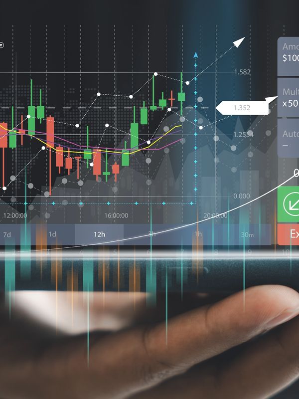 a person holding a phone with a stock chart on it