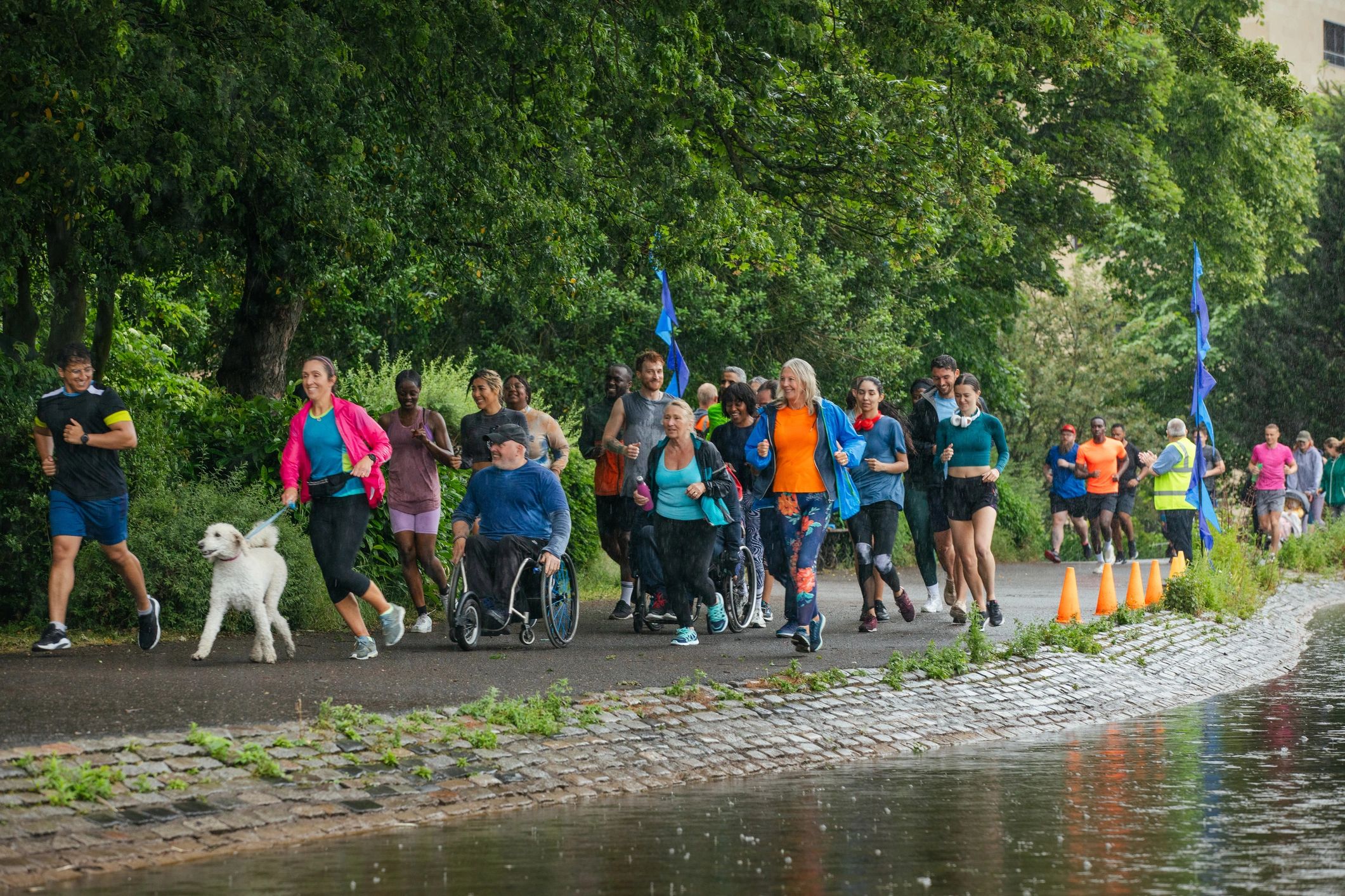 people walking along a river pathway