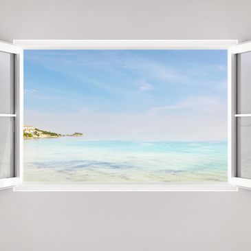 Open window showing a peaceful seaside with clear blue water and sky.