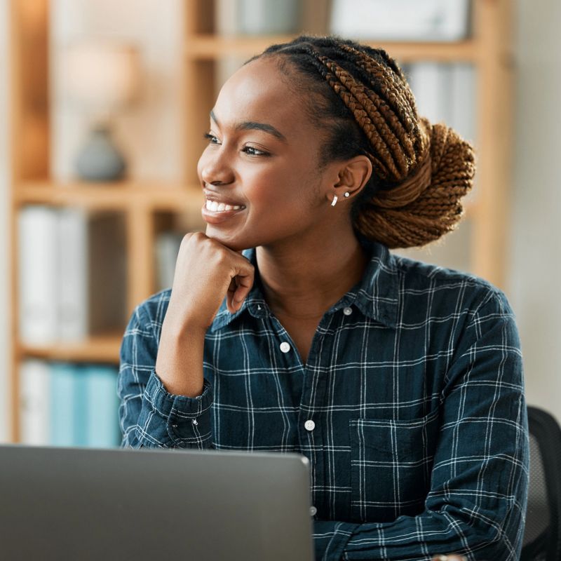Woman, thinking and computer for work from home opportunity, copywriting ideas and planning goals. Young african person, happy freelancer or writer on laptop, business vision and brainstorming online