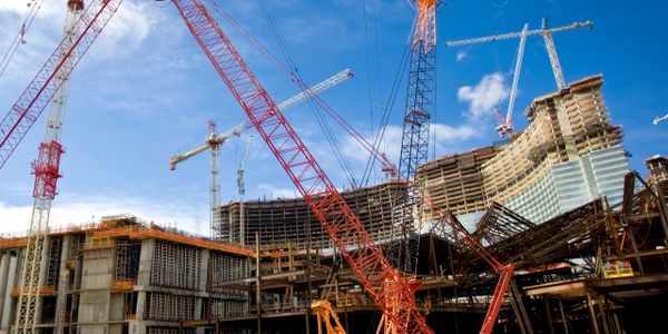 Large construction site with multiple cranes and buildings under development.