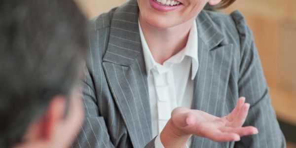 Businesswoman smiling and talking during a meeting.
