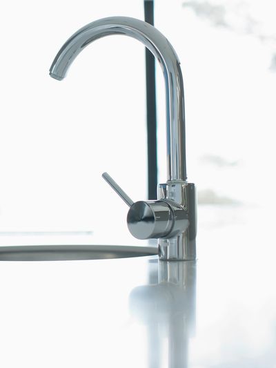 Chrome kitchen mixer tap with pull-out spray hose, illustrating kitchen tap repairs and replacements