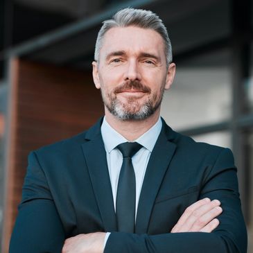 a confident mediation lawyer in a suit and tie with his arms crossed