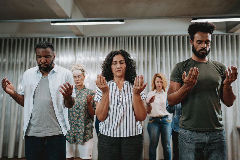 Group of people praying for mental support