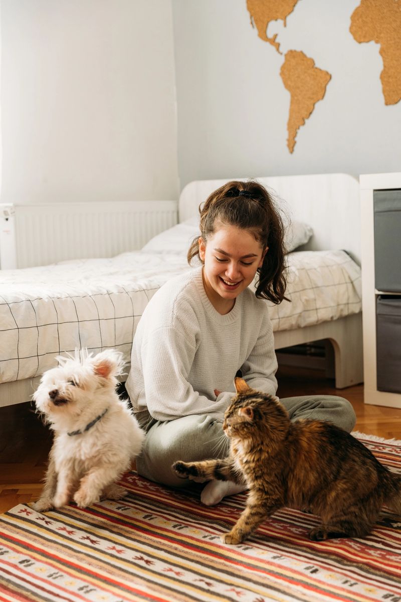 Teenage girl playing with her pets and having so much fun