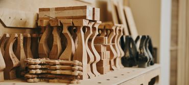 Wooden furniture parts neatly arranged on a workbench.