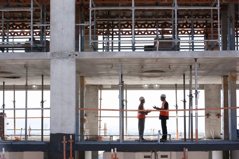 Construction workers shaking hands on construction site