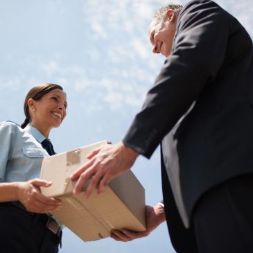 Delivery person handing over a package to a customer.