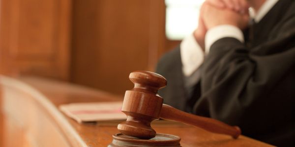 Judge with gavel in courtroom.