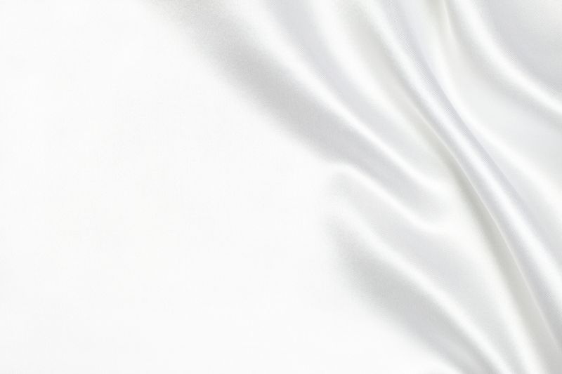 White silk background with blank space.