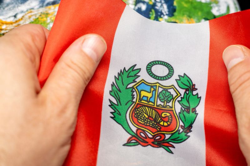 Peruvian flag clutched in hands