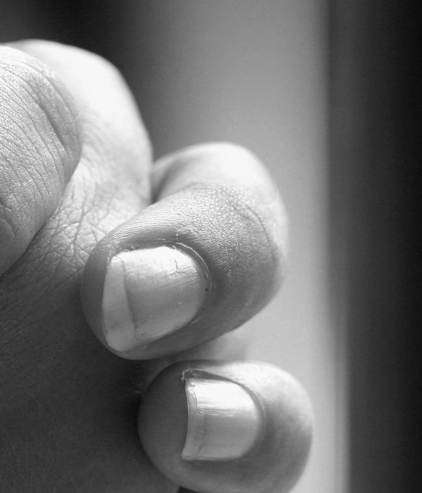 Close-up of two fingers and nails in black and white.
