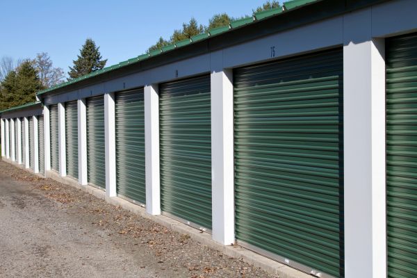 Row of green storage unit doors.