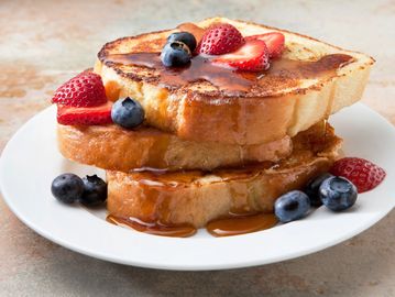 French toast with syrup and berries.