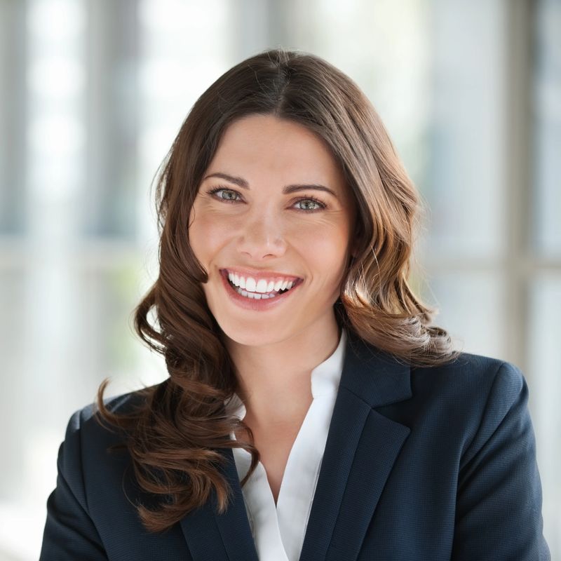 Portrait of a cheerful young Caucasian female executive. Square shot.