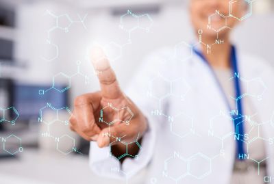 Doctor interacting with virtual chemical formulas on a transparent screen.