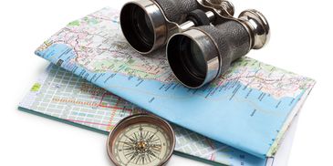 Binoculars, map, and compass for navigation.