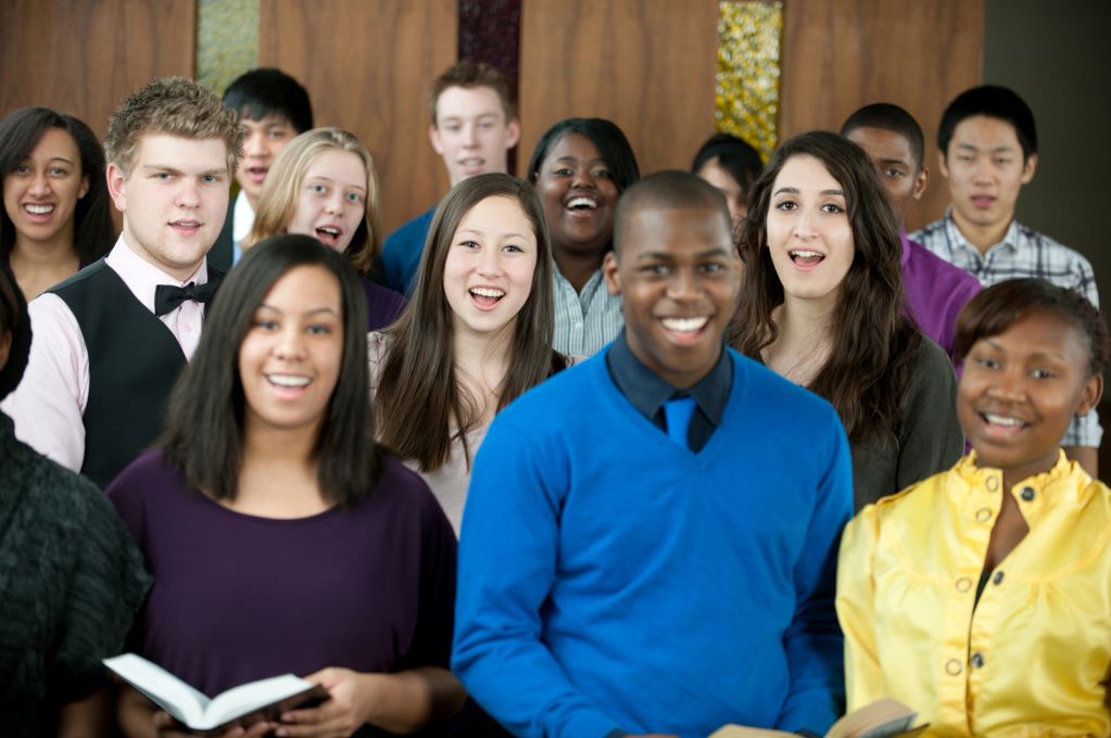 A diverse group of young people singing together.