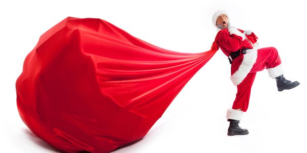 Surprised Santa struggles with an enormous red sack.