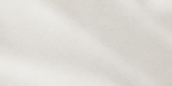 Close-up of textured white fabric with subtle folds.