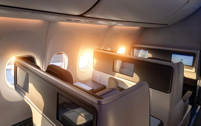 Modern airplane interiors, luxury first class and business class seats with entertainment area.