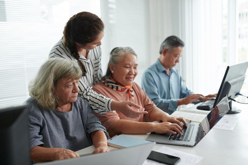 Senior women learning basic computer skills in computer class