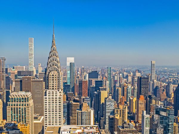A clear day view of New York City's skyline featuring the Chrysler Building.