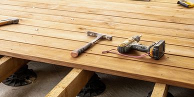 Wooden deck under construction with tools on it.