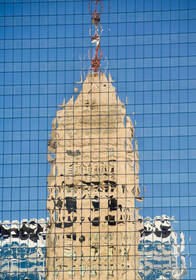 Subject: A historic highrise reflected in a contemporary highrise in downtown