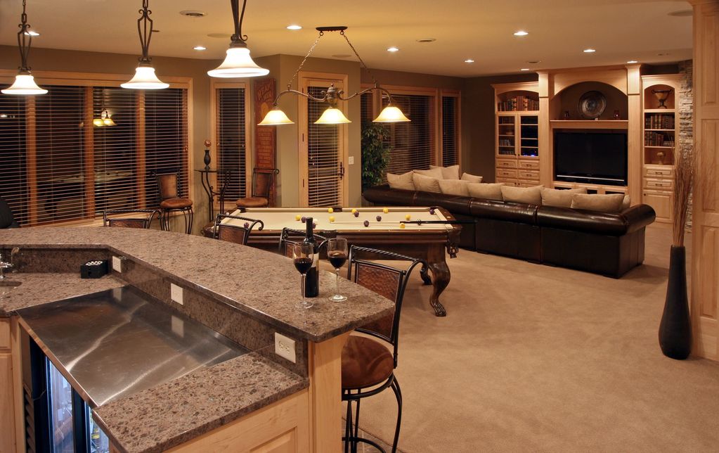 basement space with pool table tv, and bar .