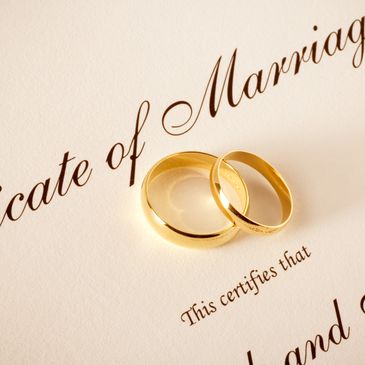 Gold wedding rings on a marriage certificate.