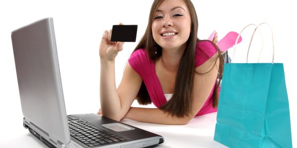 Young woman doing online shopping with laptop and credit card.