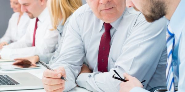Business professionals discussing documents in a meeting.