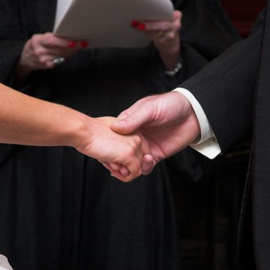 Bride and groom holding hands during wedding ceremony.