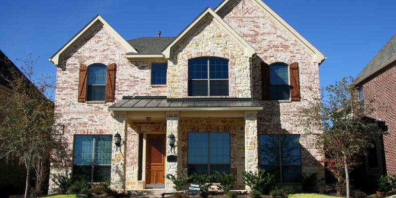 Large two-story brick house in Texas representing luxury sober living, structured sober living, and premium recovery support for men.