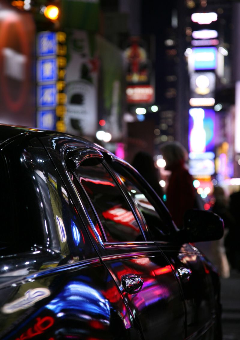 "Neon reflections on limousine in Times Square at night, New York City, NY, USA."
