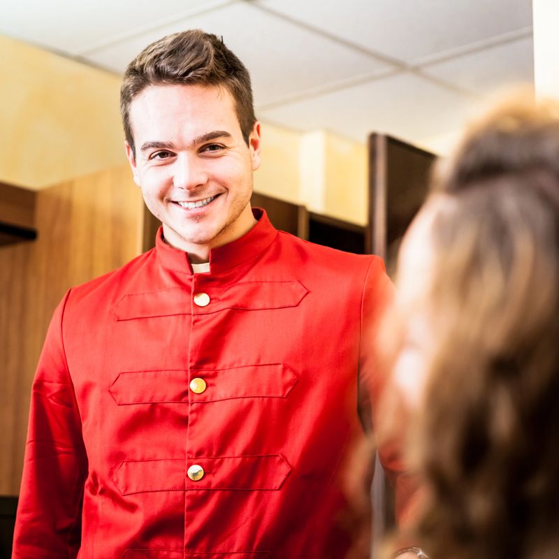 Bellhop showing the hotel room to a guest.