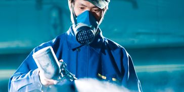 The spray gun applies a thin, even layer of protective coating (such as zinc spray)