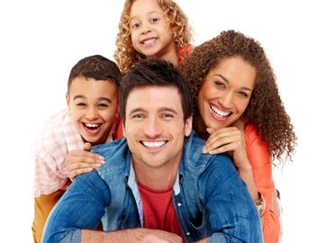 Happy family of four smiling and posing together on a white background.