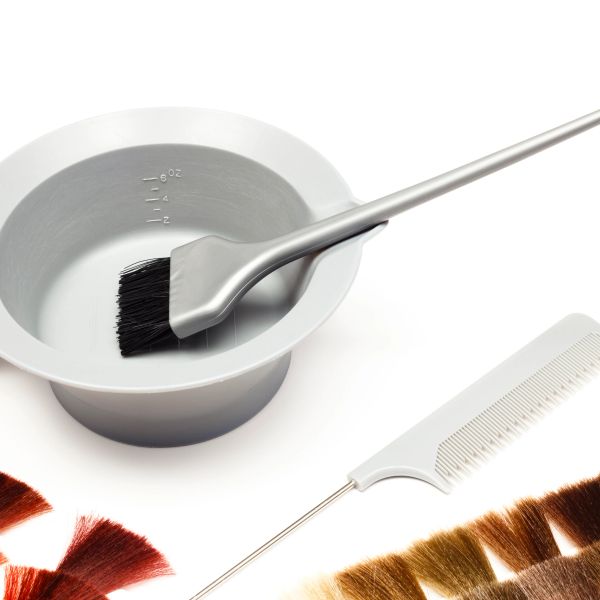 Hair dye brush and bowl with color samples and comb.