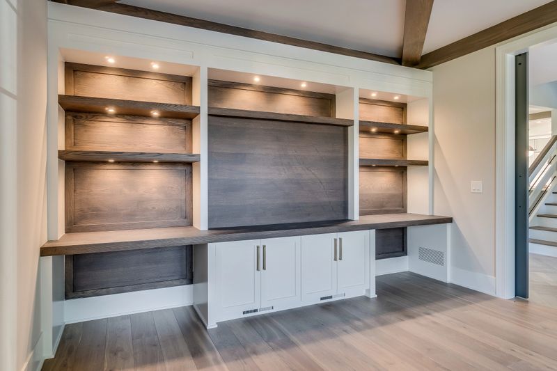 Great room with built-in shelving and cabinets