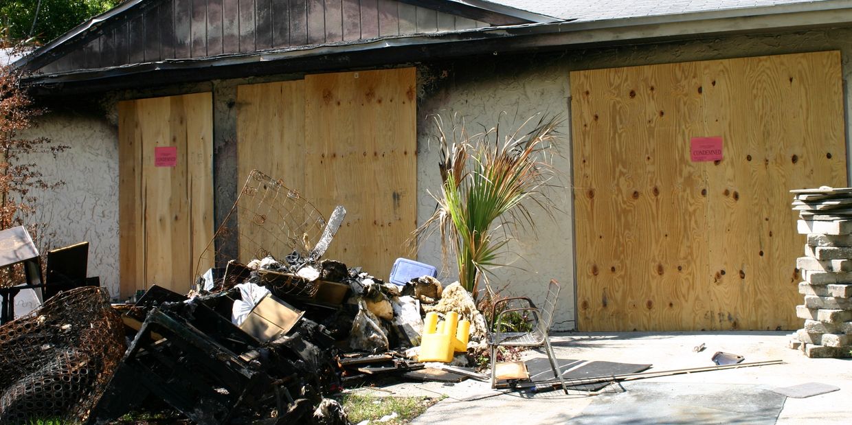 Burned home in Corona boarded up after fire