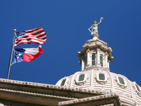 Two women engaged in a serious business discussion at an office desk.