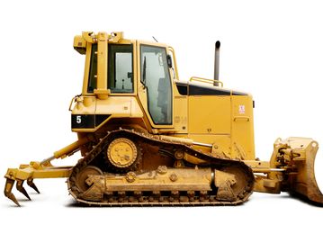 Yellow bulldozer with tracks and claws isolated on white.