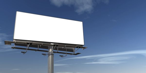 Blank billboard against blue sky.