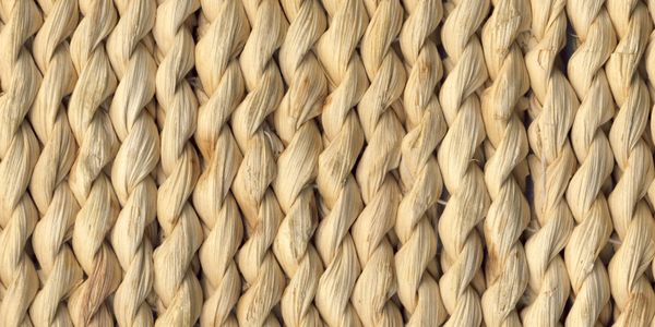 Close-up of tightly braided natural fibers in a repeating pattern.