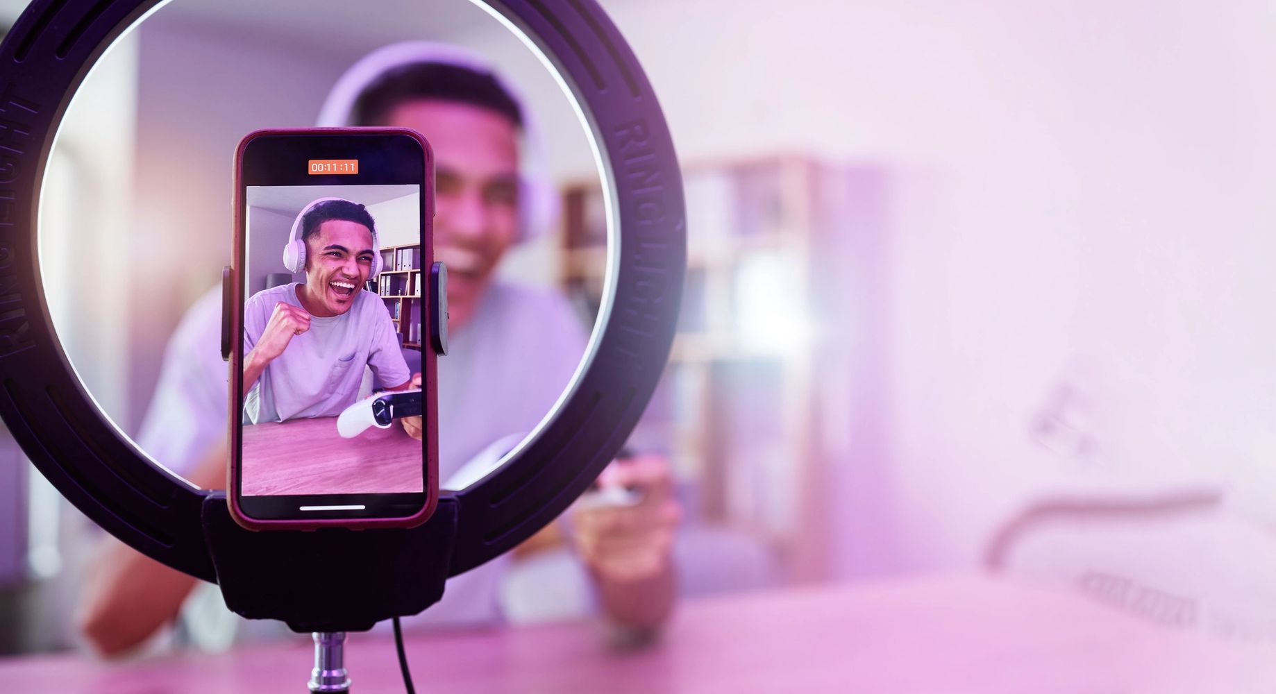 Stack of books next to pencils in a holder and a camera.