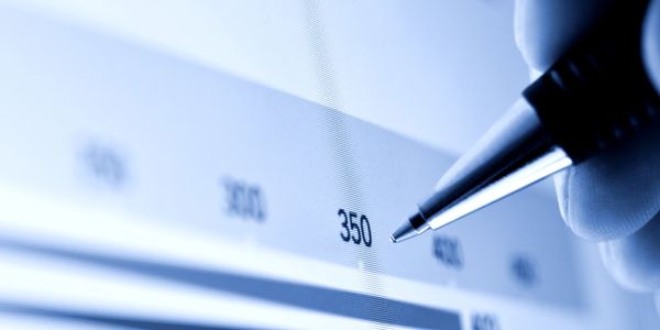 Close-up of a pen pointing at the number 350 on a chart.